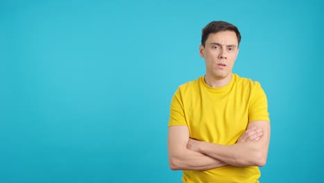 man in yellow shirt on blue background