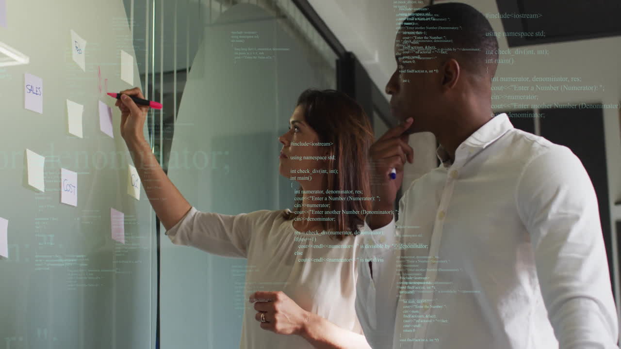In office, colleagues discussing ideas on glass board with code animation overlay