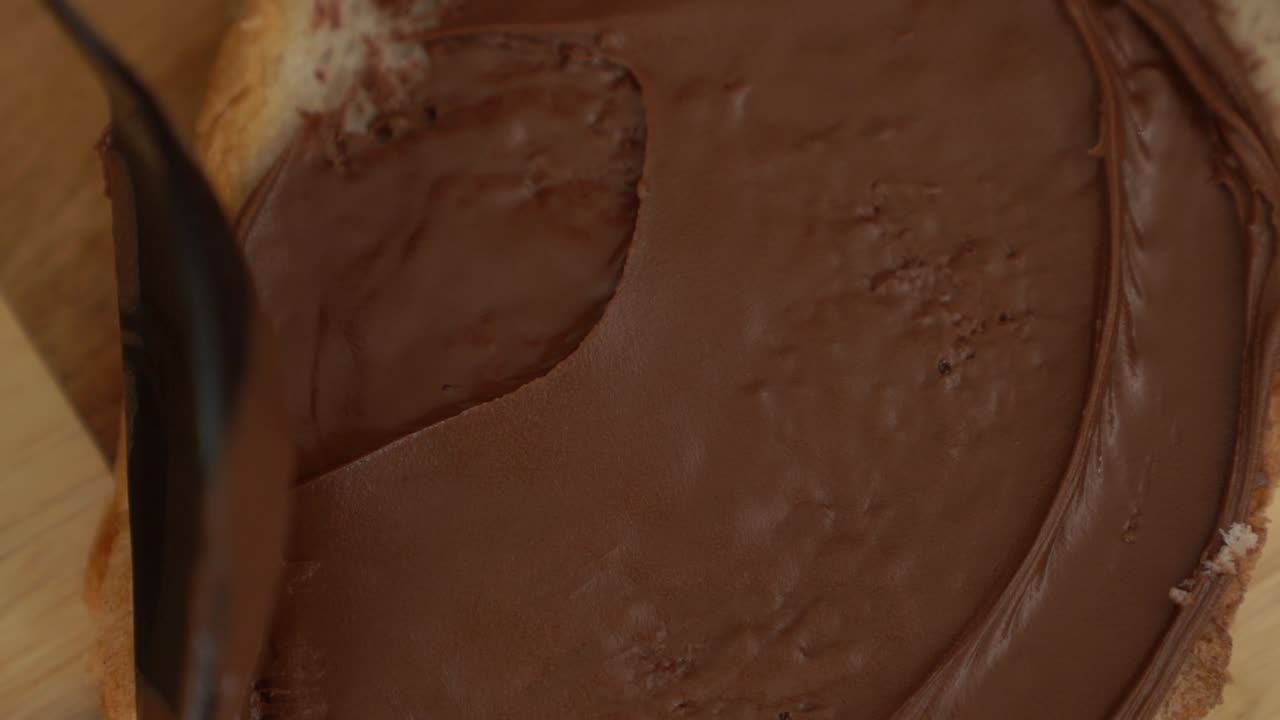 Spreading chocolate spread onto fresh toast