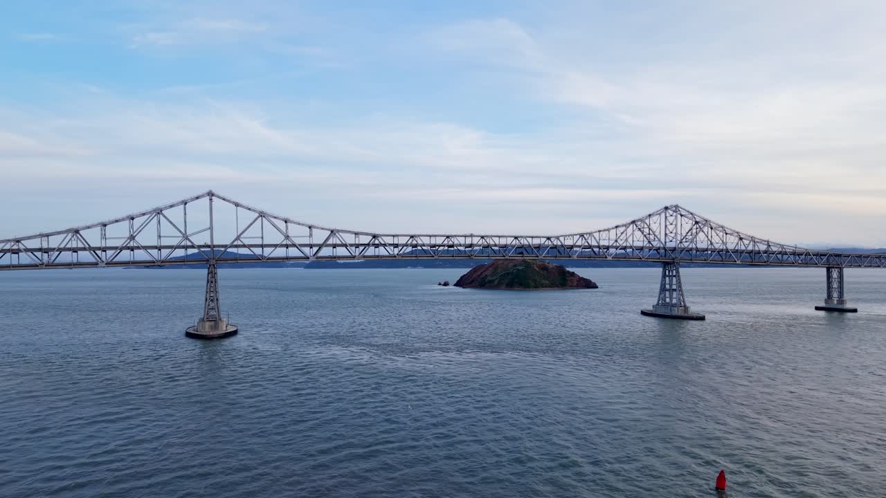 Bay waters shimmer beneath the Richmond–San Rafael Bridge as the drone reveals the structure’s elegant reach and the rhythm of distant traffic.