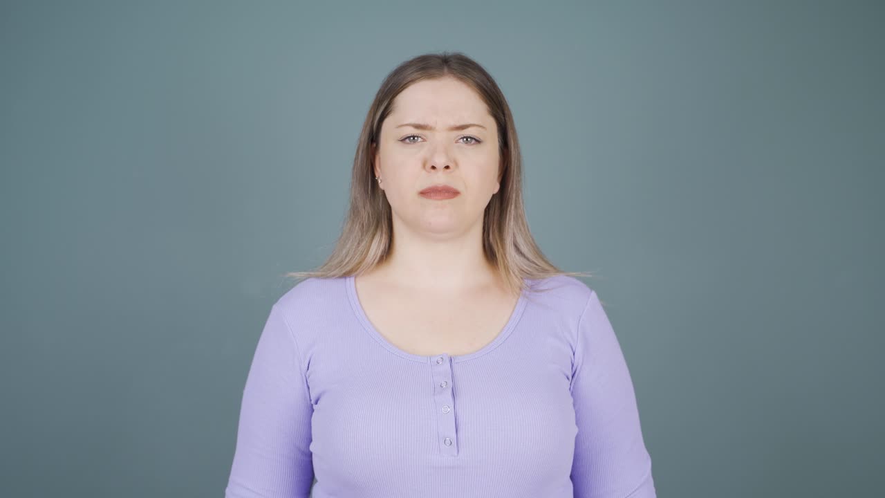 The young woman is warning by looking at the camera.