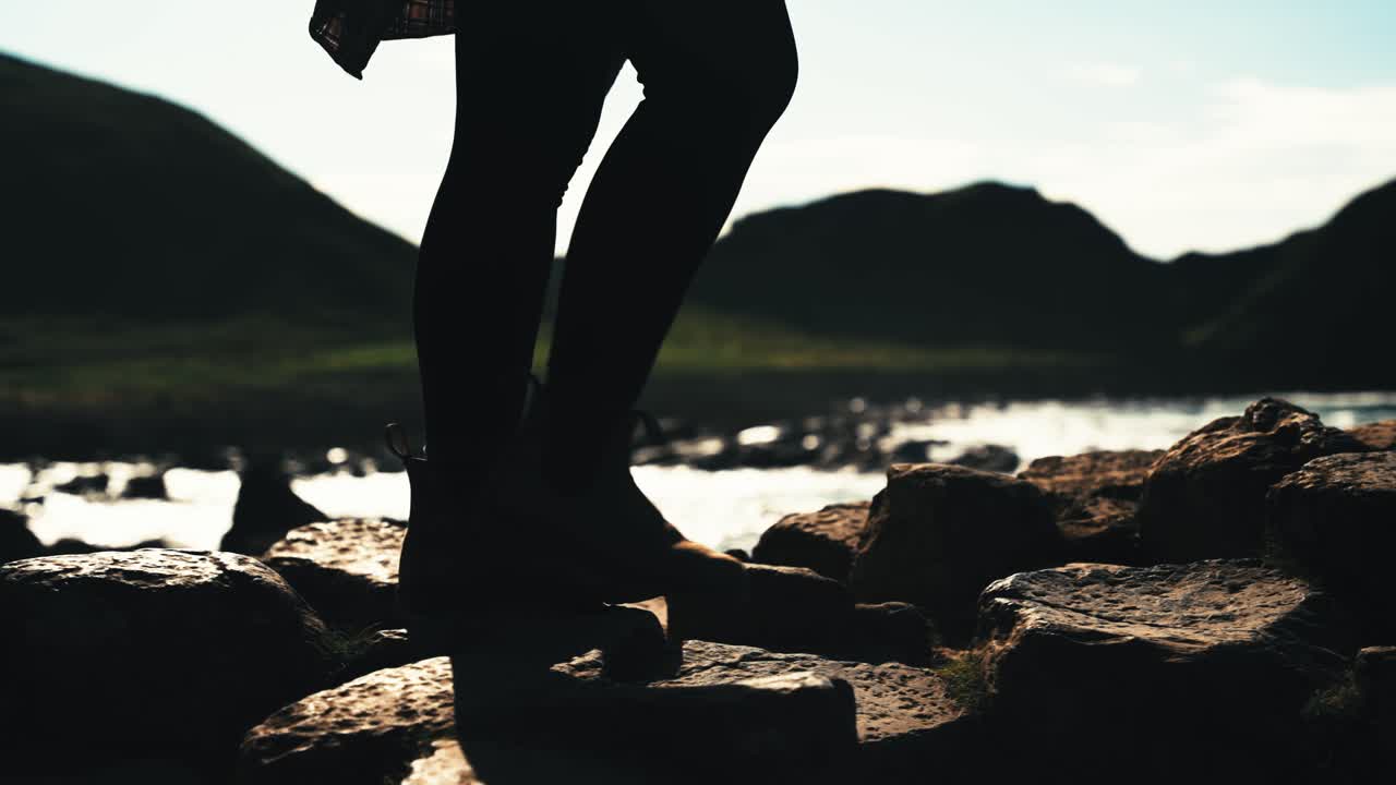 Silhouette of girls legs walking in front of ocean. Glorious slow motion.