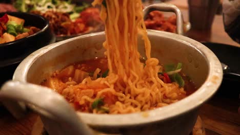 ramen noodles being prepared and served