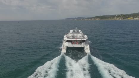 Aerial-approach-of-luxurious-big-white-yacht-sailing-in-ocean-leaving-large-wake