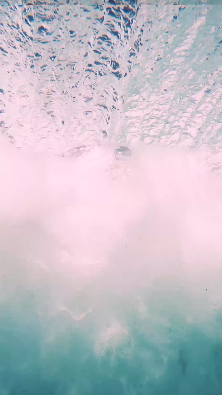 A vertical breathtaking underwater view of crashing waves