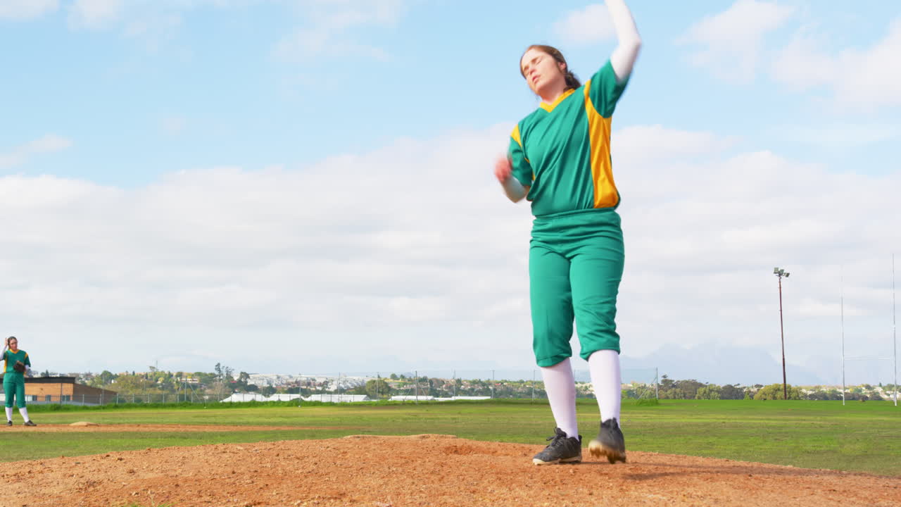 Female baseball player playing baseball, catching and throwing the ball on a pitch, copy space