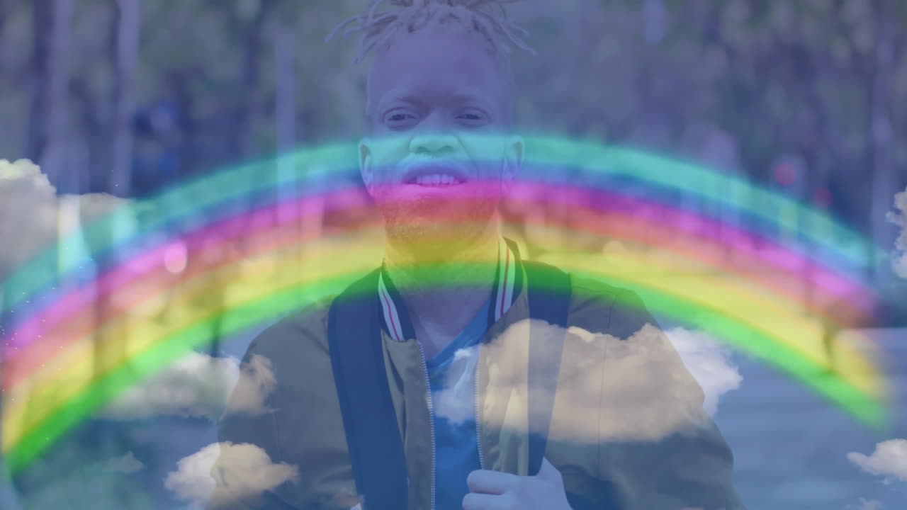 man exploring business branding concept outdoors, with rainbow graphic and cloud overlays