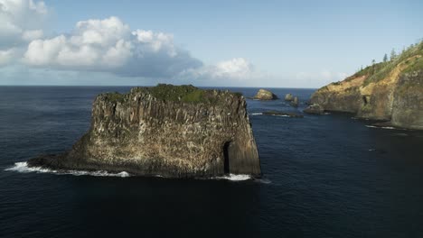 4k aerial - norfolk island, australia slow orbit and pull back from amazing rock formation dji inspire 2