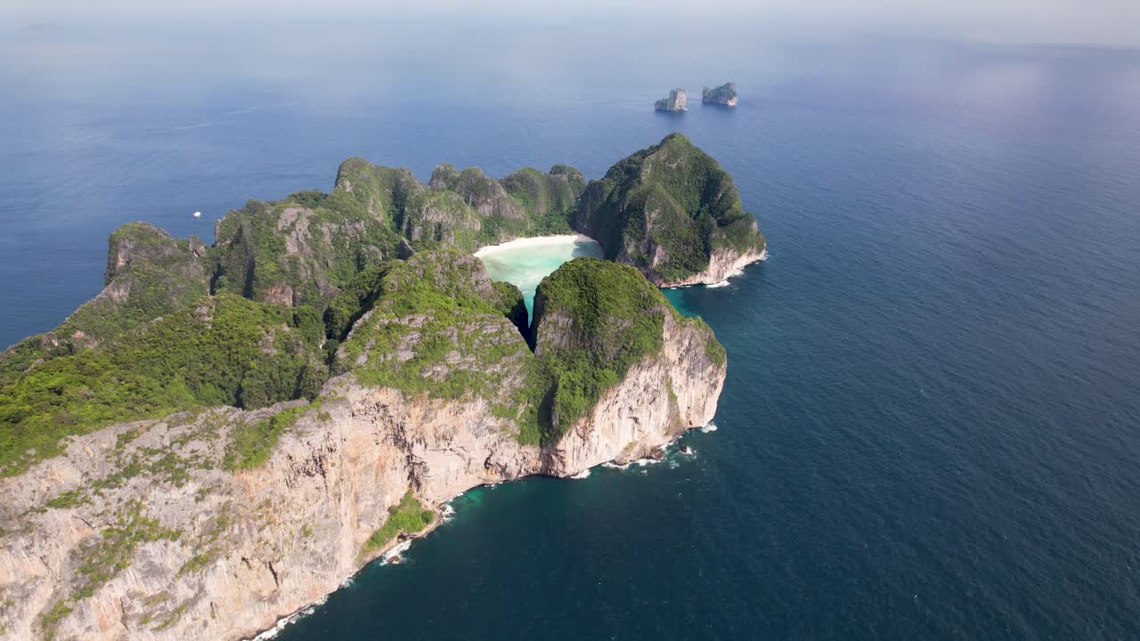 Aerial drone video of Phi Phi Leh with Maya Bay and Pileh Lagoon, Krabi province, Thailand. Aerial top view of amazing tropical island with turquoise water and white beach, famous travel destination.