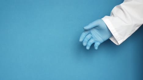 doctor's hand in blue gloves