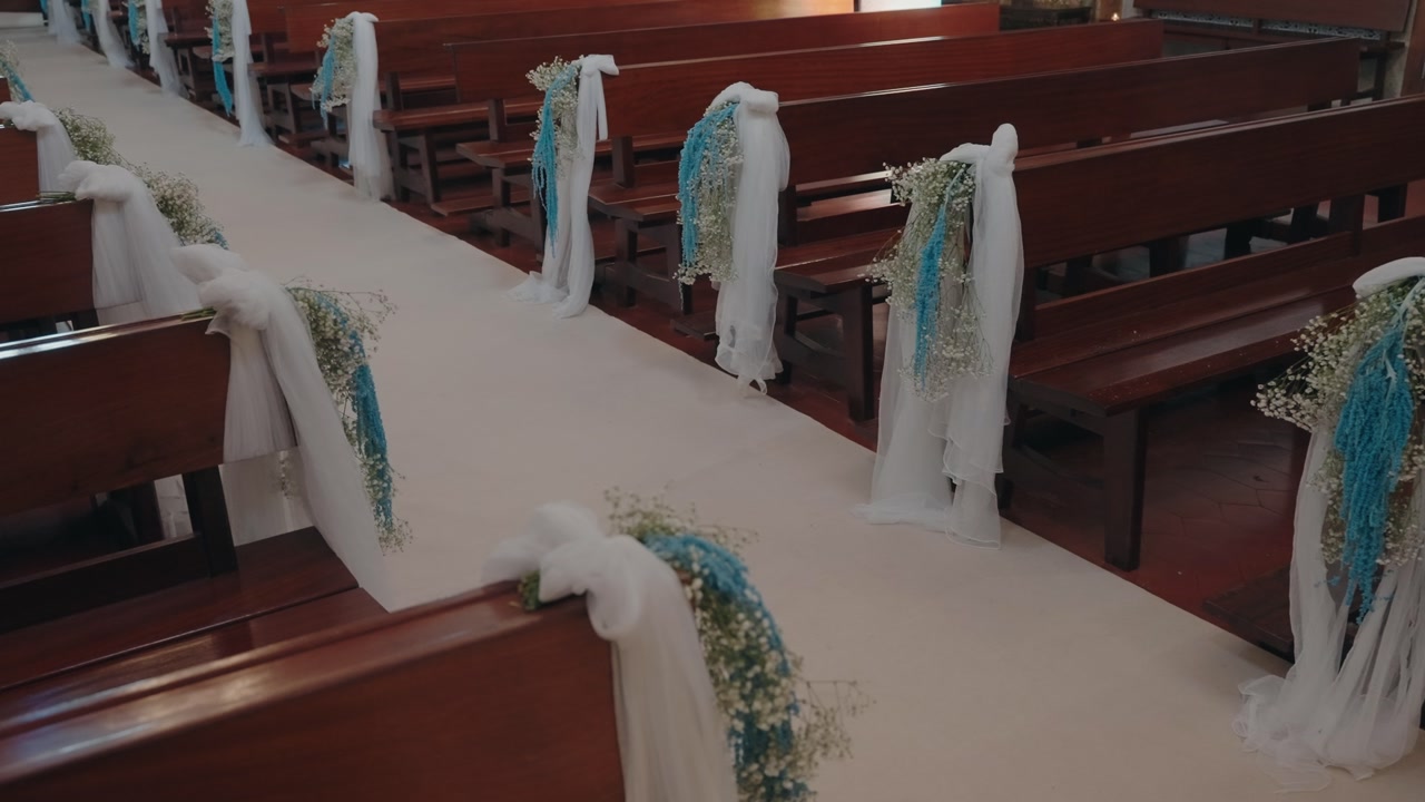 church aisle adorned with flowers and fabric for wedding ceremony