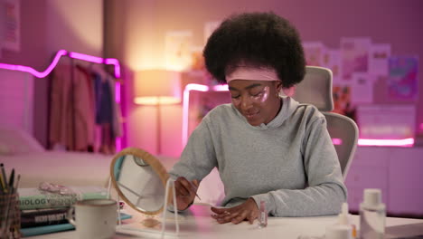 young woman applying eye patches and makeup in her bedroom