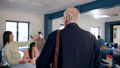classroom scene with a professor and students in a computer lab