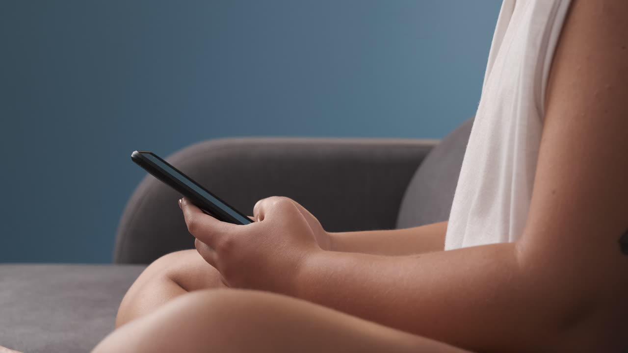 close-up of women's hands typing on the mobile