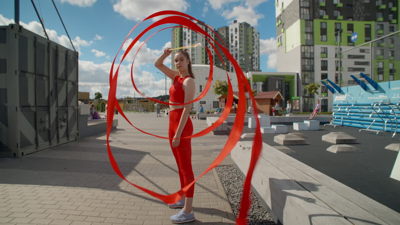 Woman Performing Ribbon Twirling Outdoors