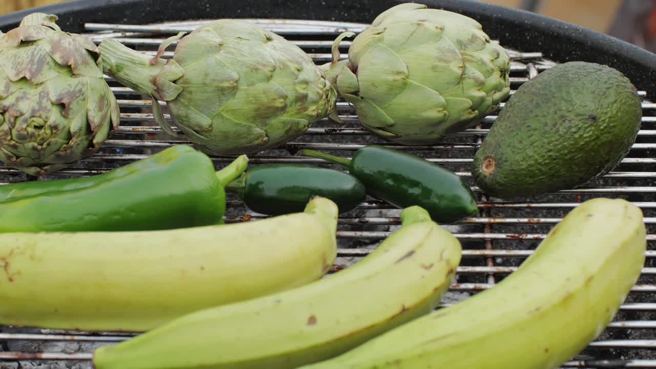 Vegan vegetarian bbq barbuque, grill Many various of green vegetables on plate close-up. Fresh artichoke, green pepper, zucchini, avocado. Cafe and restaurant food.