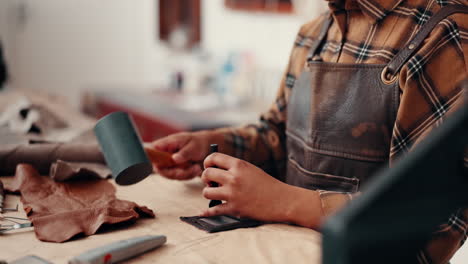 Leather-work,-hands-in-workshop-with-hammer