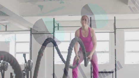 Animation-Von-Daten-Auf-Der-Benutzeroberfläche-über-Crosstraining-Einer-Kaukasischen-Frau-Mit-Battle-Ropes-Im-Fitnessstudio