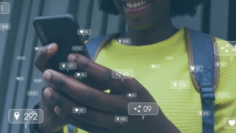 animation of icons and data processing over african american woman using smartphone