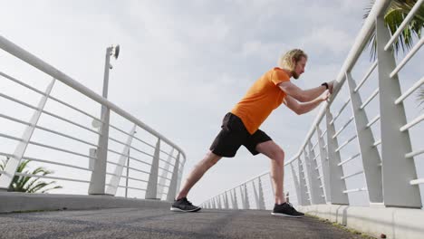 Sporty-Caucasian-man-training-on-a-bridge