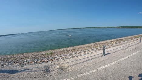 slow motion - bass boat turning away from the dam on saylorville lake in central iowa on a bright summer day