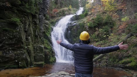 A man in a hard hat enjoys a waterfall savoring na 4k 2025 07 24 06 29 27 utc.mov | adventure, aesthetic, appreciation, beach