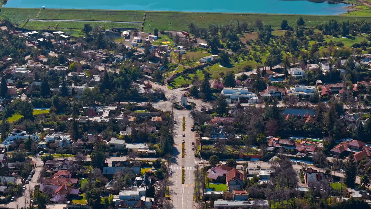 Aerial establishing fly La Dehesa Mill, Santiago de Chile, wealthy capital area, coast towards the lake, houses and neighborhood streets