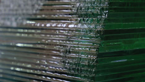 water flowing on stacked of glass sheets