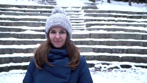 woman in winter outfit on snow covered steps