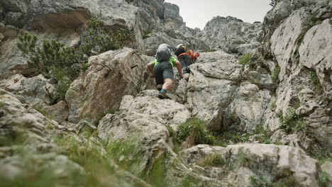 Hikers-with-backpacks-climbing-up-a-climb-in-cloudy-conditions