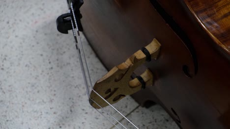 Double-Bass-resting-on-the-floor-after-an-intense-rehearsal,-Double-Bass-Player,-Beginning-Orchestra