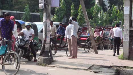 busy street scene in bangladesh with rickshaws