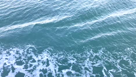 sea water waves on side of boat while moving, boat cutting water surface during cruise.