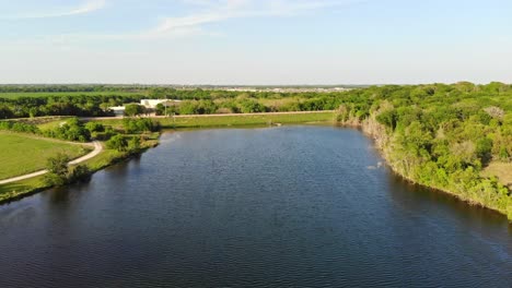 rising up and away to the left from water of a pond, reservoir, a soil conservation sight