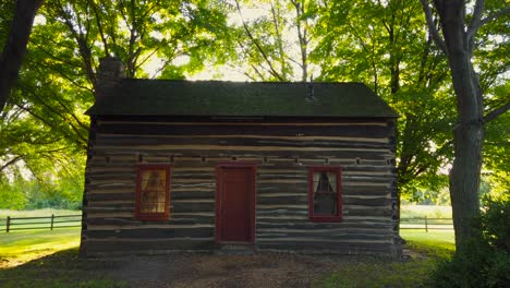 a shot of the sun behind the cabin at the historic site at the peter whitmer farm location in new york in seneca county near waterloo mormon or the church of jesus christ of latter-day saints