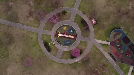 aerial rising orbit over outdoor circular playground, buenos aires