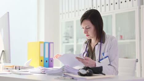 Female doctor reviewing paperwork in office