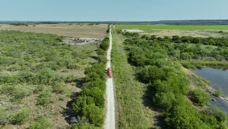 semi truck driving down a country road