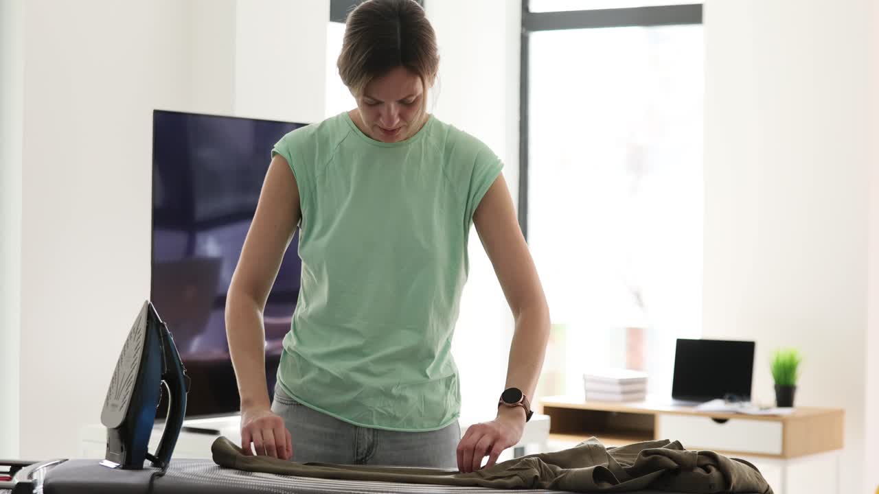 A woman ironing clothes at home