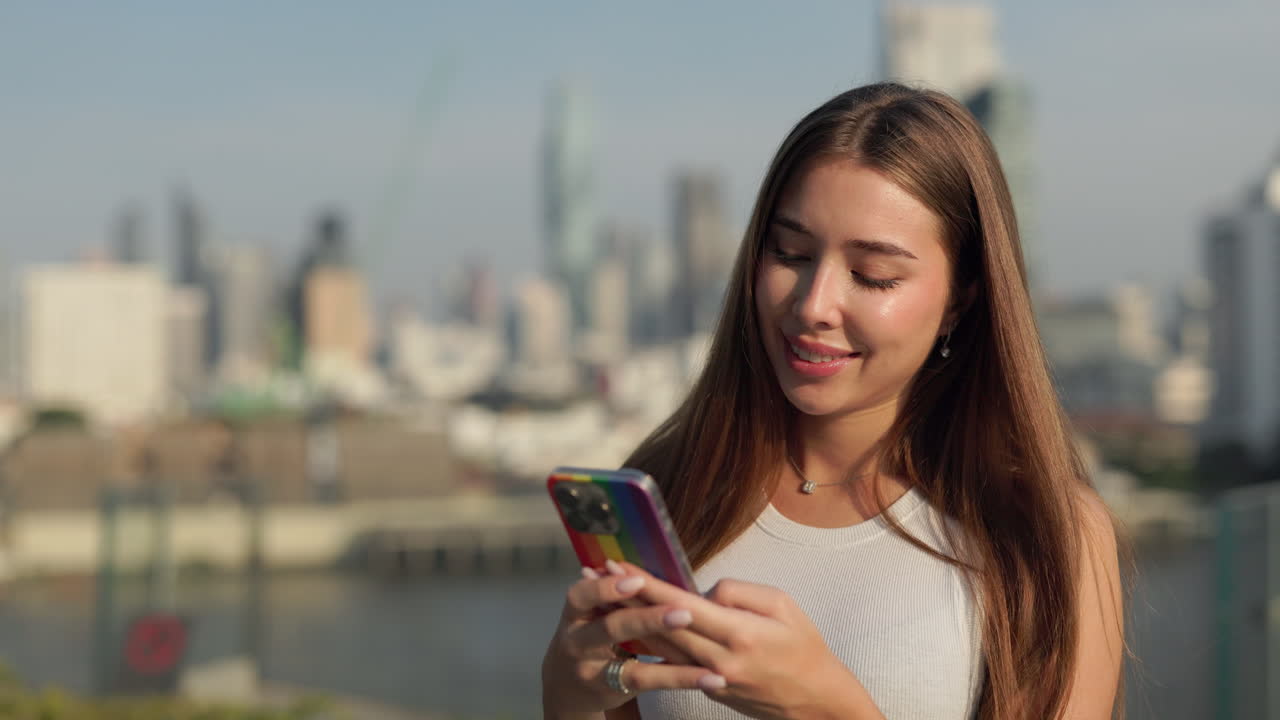 Woman using smartphone with city backdrop