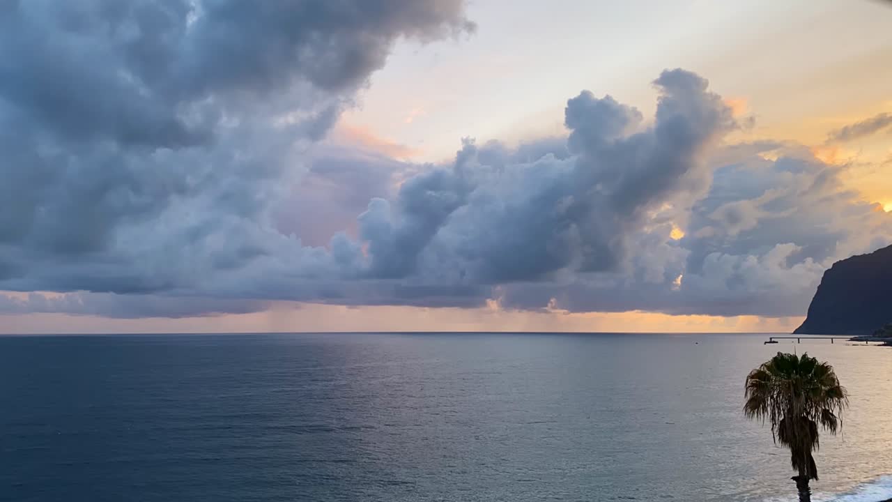 Timelapse of dramatic clouds and rippling water moving over the Atlantic Ocean at Praia Formosa in Funchal, Madeira, Portugal, capturing changing light, and a cinematic coastal atmosphere