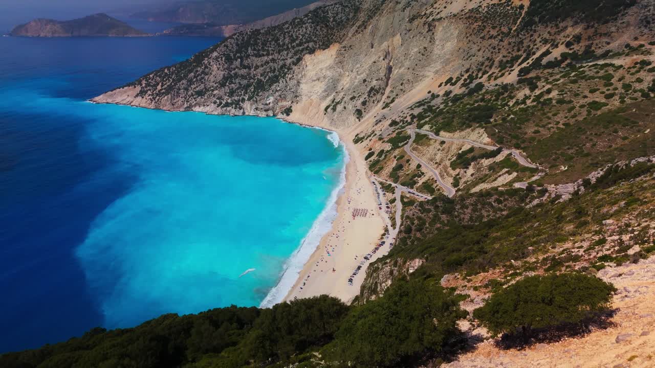 Drone Aerial and Cinematic View of the Myrtos Beach in Kefalonia. One of the most spectacular beaches in Greece and the Mediterranean. Surrounded by steep cliffs and lush green hills. DJI MINI 4PRO