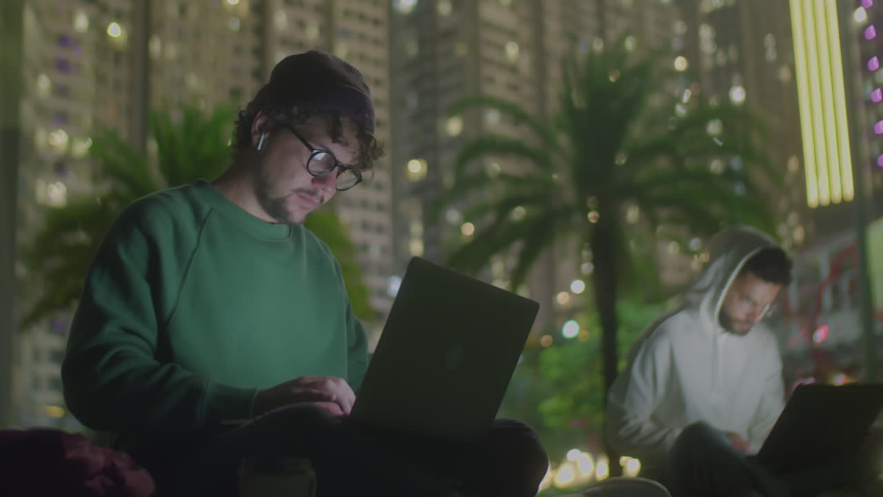 Freelancer Working on Laptop in Park at Night