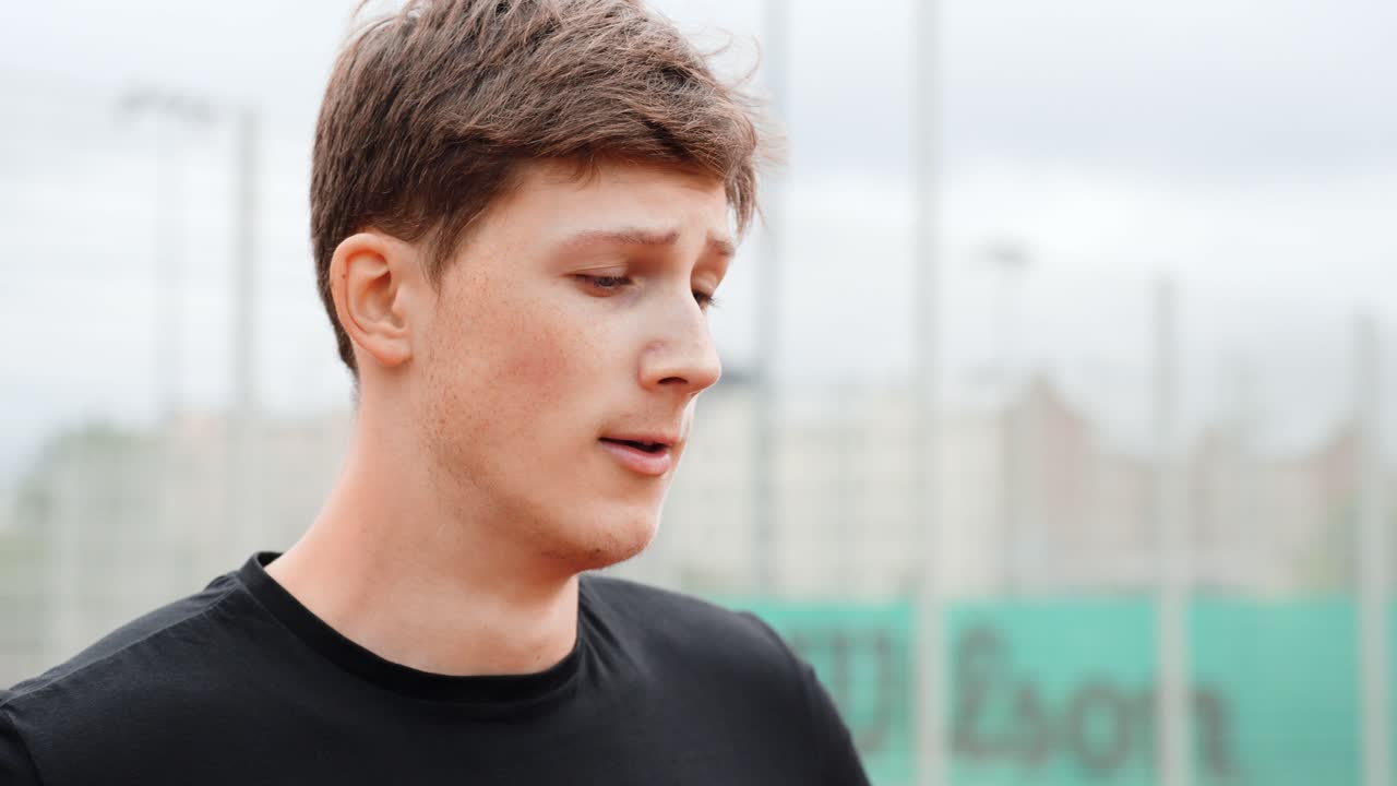 Macro shot of young man catching breath outdoors after intense exercise