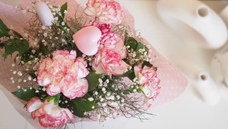 a bouquet of pink and white carnations