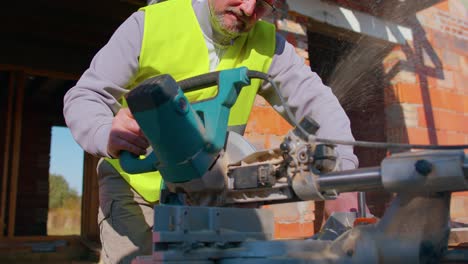 carpenter man using circular electric saw for cutting wooden boards, woodworker at construction site