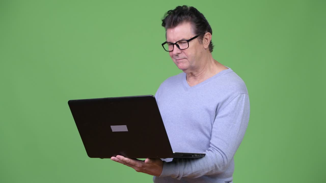 Senior handsome man using laptop