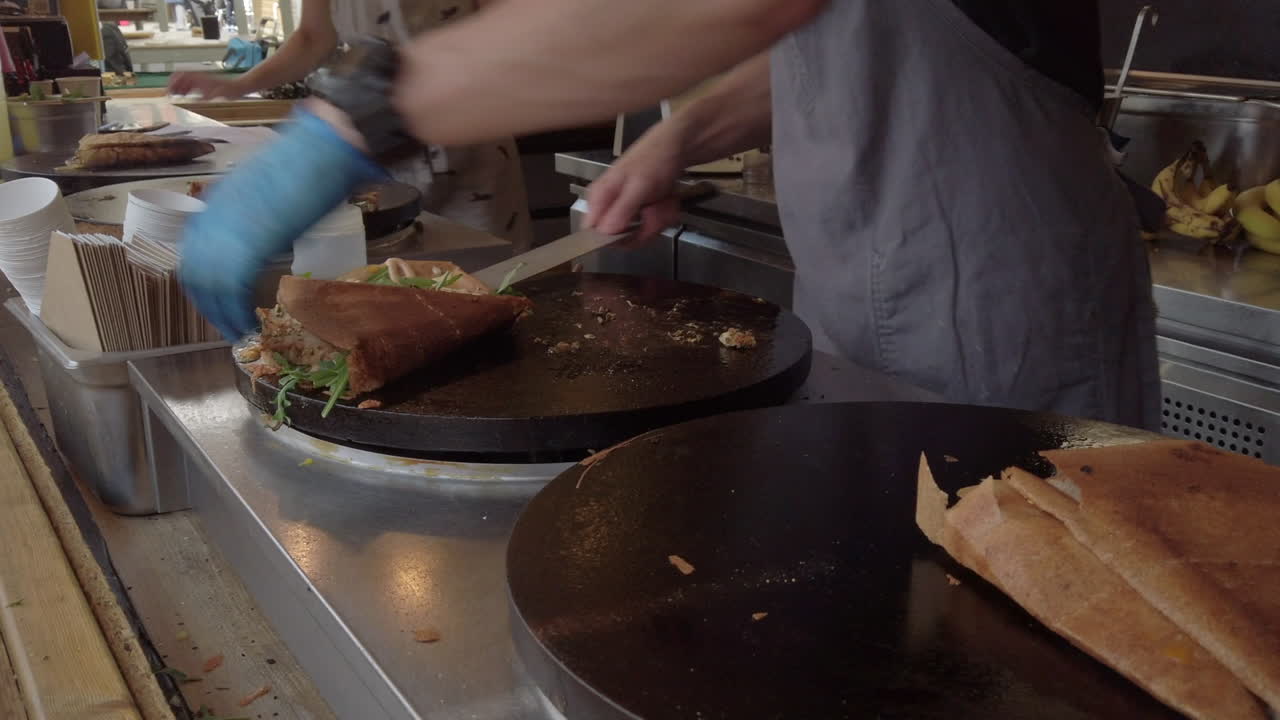 Savoury crepes being cooked on an open-air hotplate at a market stall in York, UK