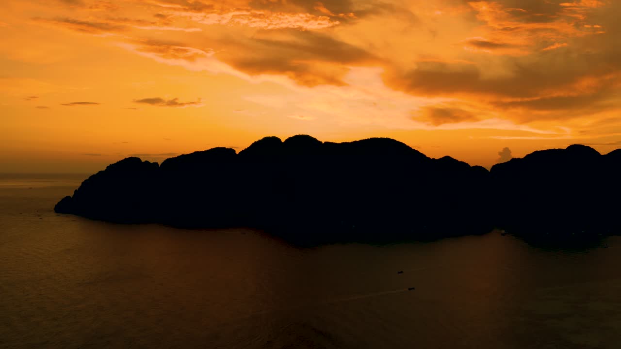 Amazing colorful sunset behind an island. Ko Phi Phi Thailand at dusk. Aerial