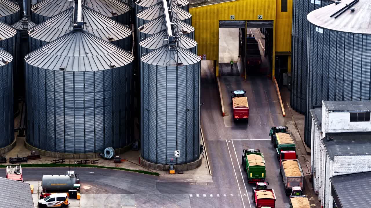 Aerial view of Grain delivery at storage tank containers weighing trucks